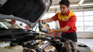 oil change in pearland mechanic pouring oil