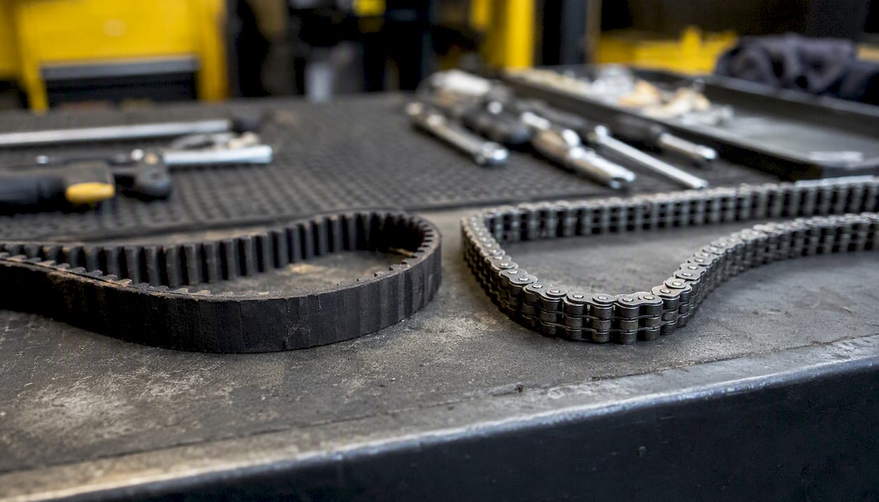 Close-up of timing belt and timing chain side by side