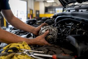 Mechanic hands replacing alternator close-up