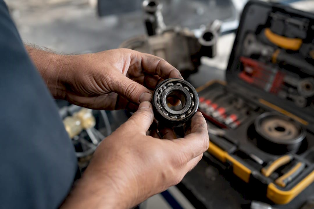 Close-up of AC compressor bearing being inspected
