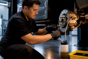 Technician performing brake fluid flush