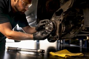 Technician replacing an exposed wheel bearing