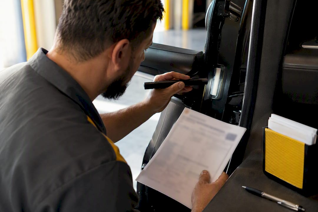 Technician verifying vehicle inspection documents