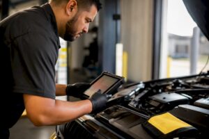 Technician documenting vehicle condition digitally