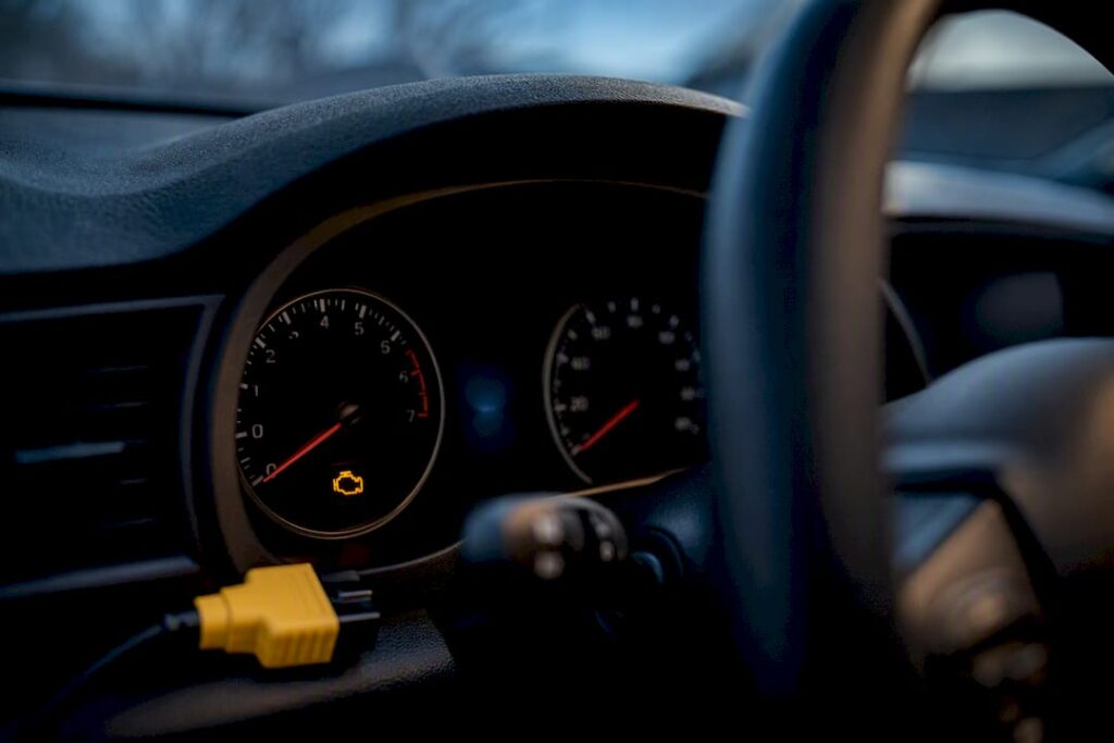 Flashing check engine warning light on dashboard