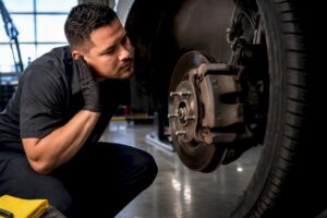 Technician inspecting an anonymous brake assembly