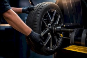 Technician mounting wheel on balancing machine