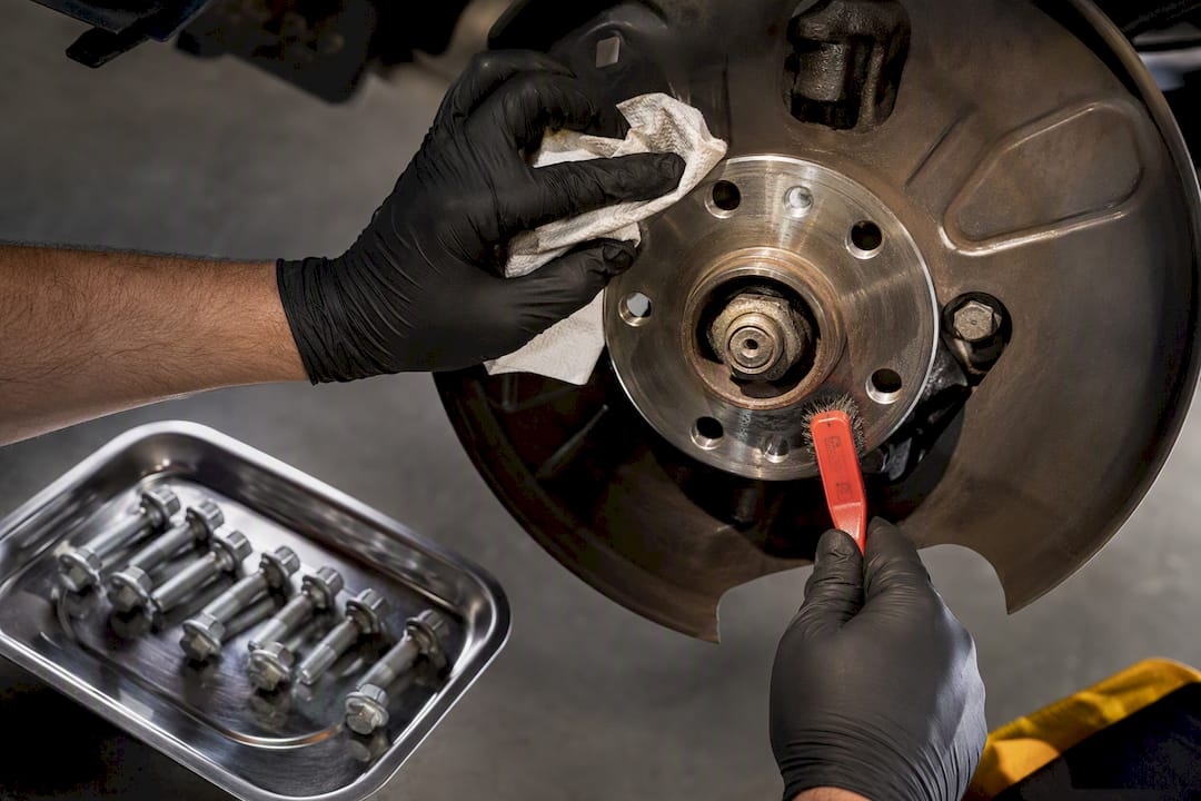 Technician cleaning brake hub flange