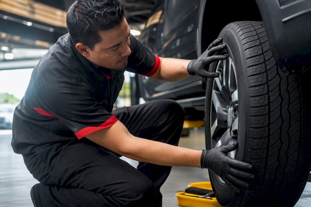 Technician inspecting tire tread for rotation