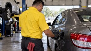 Technician inspecting a car fuel cap